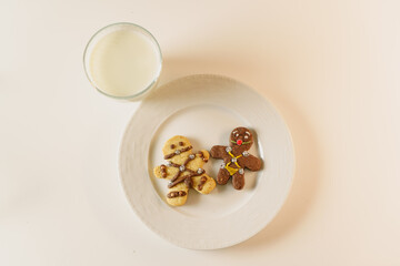 BDSM themed gingerbread cookies. fun looking cookies and a glass of milk. Sexy cookie with mouth ball and leather suit look designed in bsdm style.