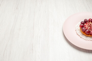front view little cake with grapes inside plate on a white background fruit dessert cake