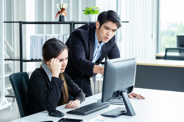 Stressed of businesswoman and businessman partners discussing positive adult business working together with computer on wooden table and ideas at meeting in office background.