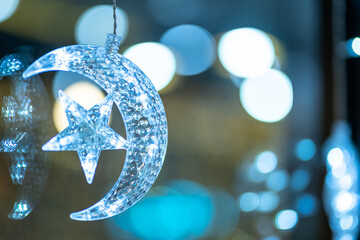 Christmas decoration lights in the crescent moon and shape of a star for with rope on Bokeh background Decoration During Christmas and New Year. © Thinapob