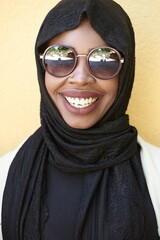 african woman using smartphone wearing traditional islamic clothes