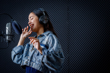 Happy cheerful pretty smiling of portrait of young Asian woman vocalist Wearing Headphones...