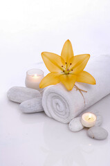 Composition with towel, spa stones and candles on white background