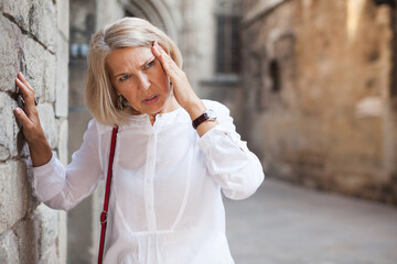 Elderly woman felt bad on city street. High quality photo