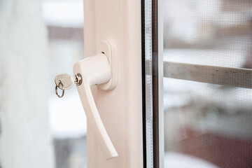 installation of a lock with a key on a plastic window, safety concept for opening the frame