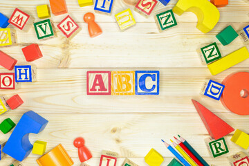 Educational toys blocks, numbers, letters on wooden table. Toys for kindergarten, preschool or...