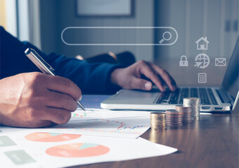 Business man  working with computer on desk office analyze document in his hands.Graphs and diagrams on Mobile phone Store order information