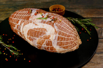 Raw pork neck ready for cooking on wooden background.