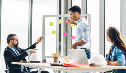 Obraz premium Group of professional business meeting and discussing strategy with new startup project.Creative business people planning and brainstorm with document report in modern workloft.Teamwork concept