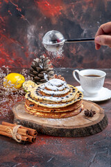 front view tasty sweet pancakes with sugar powder on dark background milk dessert sweet