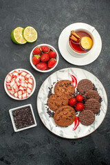 top view choco biscuits with cup of tea on dark background photo sweet cookie