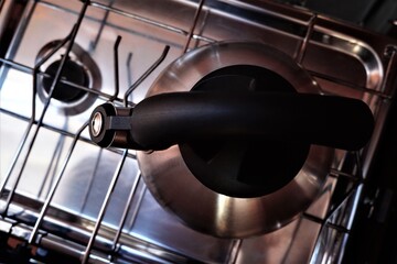Whistling kettle on gimballed gas stove in sailing yacht.