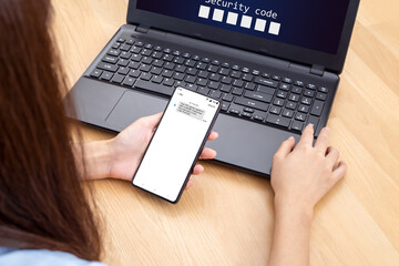 Woman hand enter a one time password for the validation process, Mobile OTP secure Verification Method, 2-Step authentication web page.