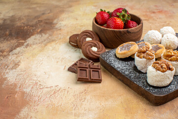 front view different sweets with cookies and fruits on light desk fruit sugar pie cake