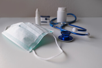 lot of disposable medical masks, stethoscope, concept of individual protection against virus,...