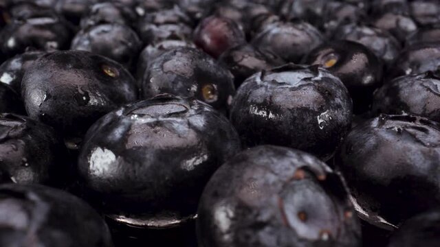 macro view passing over turning blueberries on glass, 4k shot of healthy fresh fruit, nutritional diet, blueberry acai
