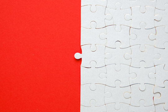 A Picture Of Empty Jigsaw With 1 Wrong Place On Red Background. Temporary Solution Concept.