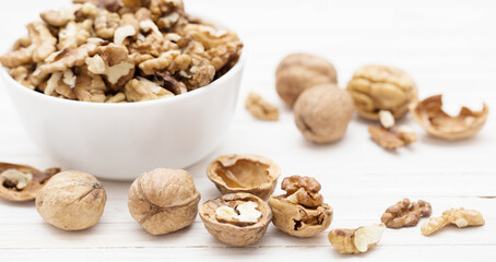 walnuts in  white plate on  white wooden table