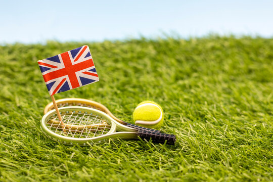 Tennis England with flag and racket on green grass - Powered by Adobe