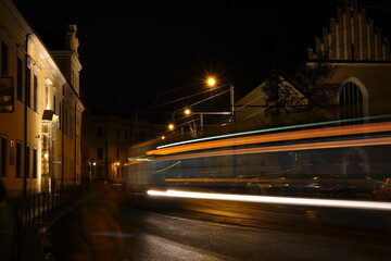 night view of the city Krakow, colorful trails of tram lights