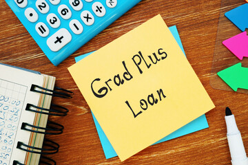 Conceptual photo about Grad Plus Loan with handwritten phrase.