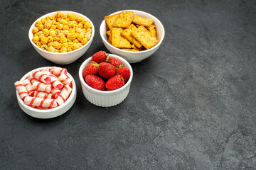 front view fresh strawberries with different snacks on a grey background fruits biscuit sweet