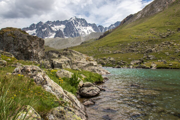 Turquoise Color lake at the Arsine pass in the Parc des Ecrins in the Haute Alps Department in France