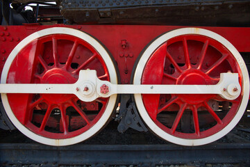 Large steam locomotive wheels are red.