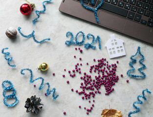 Fototapeta na wymiar New Year composition with tinsel, cones, glitters, balls, numbers 20201 and keyboard.