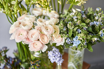 Set of white and blue flowers for Interior decorations. The work of the florist at a flower shop. Fresh cut flower. European floral shop. Delivery fresh cut flower