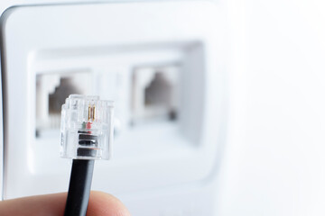 telephone socket and telephone cable on the wall