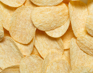 top view of golden crispy potato chips, snack texture and background.