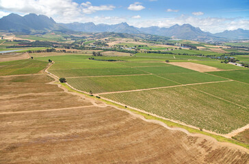 Cape Town, Western Cape / South Africa - 11/26/2020: Aerial photo of farming fields with mountains in the background