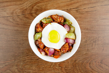 Delicious Korean food Spicy Chicken Rice serve in white bowl