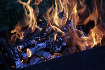 Fire and coals in the grill. Fiery background.
