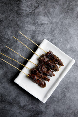 Beef and mutton satay on a white plate