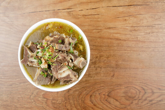 a bowl of chicken porridge with salted egg