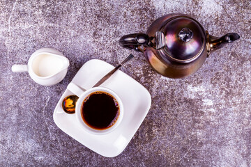 Espresso coffee in white porcelain cup and cream in a portioned jug