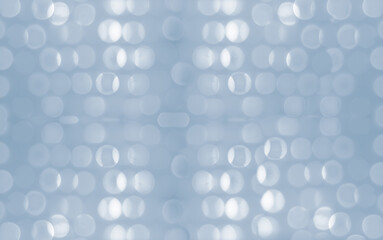 New Year and Christmas holiday concept. Shimmer glitter bokeh wallpaper. Sparkle blue rounds on gray background. Ultimate Gray color of the year 2021. 