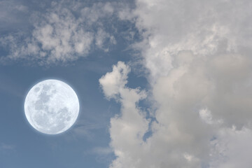 Naklejka na ściany i meble Full moon and blurred clouds on the sky. 