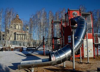 Children's play construction against the backdrop of an Orthodox Cathedral under construction in Chelyabinsk, Russia.