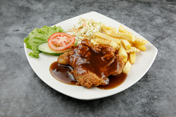 a plate of chicken chop set come with french fries and coleslaw