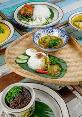 Nasi Lemak with sambal tempoyak petai serve on a rattan tray
