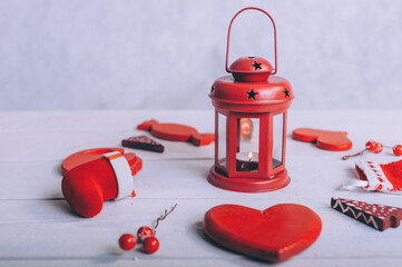 Red lamp with festive decoration for the new year on a wooden background.