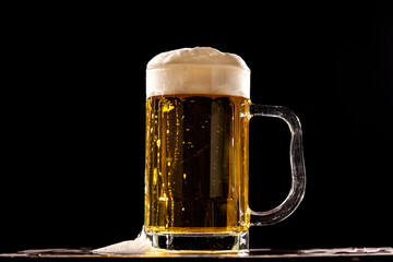 A cold fresh beer in front of a black background