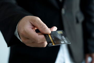 Businessman's hand gives credit cards, credit card shopping ideas and online spending.