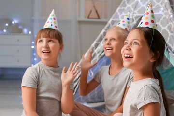 Cute little girls celebrating birthday at home