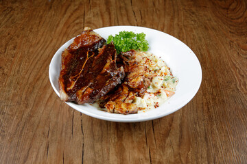a plate of carbonara pasta with grill lamb shoulder