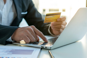 business hands shopping,paying online using laptop and credit card.