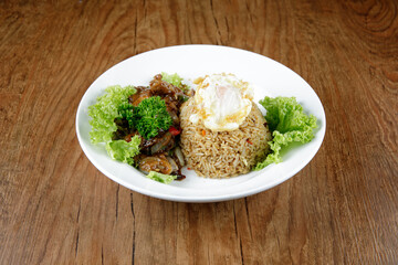 a plate of fried rice with black paper beef and fried egg